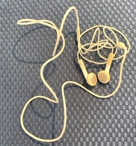 A closeup of corded Apple earbuds.