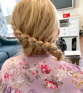 A photograph of the back of a blonde woman's head shows an elaborate, diagonal braid.