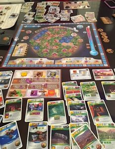 A close-up photo showing the game pieces, cards, and playing board of the Terraforming Mars game all spread out on a table; this is how it looks when the game has just been completed.