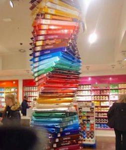A colorful Ritter Sport chocolate bar sculpture stands right in the middle of the crows at the Ritter Sport store/museum in Berlin, Germany.
