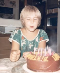Peggy making a wish as she blows out the candles on her birthday cake.
