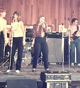 Peggy singing lead along with her band.