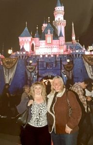 Peggy and Tahoe in front of Sleeping Beauty Castle in Disneyland.
